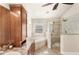 Well-lit bathroom featuring a double vanity, soaking tub, and a glass-enclosed shower at 1880 Lorraine Way, St Cloud, FL 34769