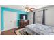Well-lit bedroom with hardwood floors features a closet, dresser with a TV, and a patterned rug at 1880 Lorraine Way, St Cloud, FL 34769