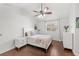 Cozy bedroom with hardwood floors, a ceiling fan, and a view to the outdoors at 1880 Lorraine Way, St Cloud, FL 34769