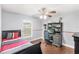 Charming bedroom features a ceiling fan and a built in desk with shelves at 1880 Lorraine Way, St Cloud, FL 34769