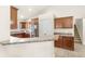 Well-lit kitchen featuring stainless steel appliances and brown wood cabinets at 1880 Lorraine Way, St Cloud, FL 34769