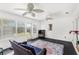 Bright sunroom with ample windows and an outdoor view, complete with wicker furniture and ceiling fans at 1880 Lorraine Way, St Cloud, FL 34769