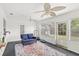 Inviting sunroom offers a relaxing space with a loveseat and access to the outdoors at 1880 Lorraine Way, St Cloud, FL 34769