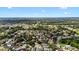Expansive aerial shot showcasing a neighborhood, trees, and a pond amidst a sprawling landscape at 1919 River Park Blvd, Orlando, FL 32817