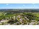 Aerial view featuring a community with a pool and pond surrounded by lush green trees and residential buildings at 1919 River Park Blvd, Orlando, FL 32817