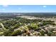 A sprawling aerial view of a residential neighborhood with lush green trees and a distant city skyline at 1919 River Park Blvd, Orlando, FL 32817
