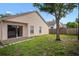Backyard with sliding glass door access and partial fence, perfect for outdoor living at 1919 River Park Blvd, Orlando, FL 32817