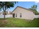Home's backyard with ample green space, updated white fence and patio access at 1919 River Park Blvd, Orlando, FL 32817