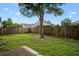 Spacious backyard featuring a wood fence and a mature tree providing shade at 1919 River Park Blvd, Orlando, FL 32817