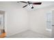 Carpeted bedroom featuring neutral walls and a ceiling fan and window at 1919 River Park Blvd, Orlando, FL 32817