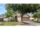 Charming single-story home featuring a well-manicured lawn, arched entry, and attached two-car garage at 1919 River Park Blvd, Orlando, FL 32817