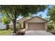 Charming single-story home featuring a well-manicured lawn, arched entry, and attached two-car garage at 1919 River Park Blvd, Orlando, FL 32817