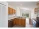 Well-lit kitchen open to the living area, offering views of the backyard through sliding glass doors at 1919 River Park Blvd, Orlando, FL 32817
