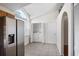 Tiled laundry room featuring washer/dryer, shelving, and a stainless-steel refrigerator at 1919 River Park Blvd, Orlando, FL 32817