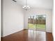 Spacious room featuring hardwood floors, natural light, and sliding glass door access to the backyard at 1919 River Park Blvd, Orlando, FL 32817