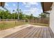 Wooden deck in backyard overlooking a grassy lawn and mature trees, enclosed by a wood fence at 2040 E Triangle Dr, Longwood, FL 32779
