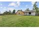 Rear exterior showing house with large grassy lawn extending to the fenced property line at 2040 E Triangle Dr, Longwood, FL 32779