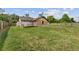 Exterior view of home with a spacious yard, a wooden fence, and lush greenery at 2040 E Triangle Dr, Longwood, FL 32779