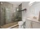 This bathroom has a glass shower with stone floors, a modern vanity, and a round mirror at 2040 E Triangle Dr, Longwood, FL 32779