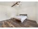 This bedroom features hardwood floors, a ceiling fan, and a bed with a patterned comforter at 2040 E Triangle Dr, Longwood, FL 32779