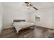 Bright bedroom with wood-look floors, ceiling fan, and a window for natural light at 2040 E Triangle Dr, Longwood, FL 32779