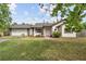 Charming single-Gathering home featuring a brick and white exterior, well-maintained lawn, and attached garage at 2040 E Triangle Dr, Longwood, FL 32779