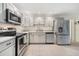 Modern kitchen with stainless steel appliances, quartz countertops, and ample cabinet space at 2040 E Triangle Dr, Longwood, FL 32779