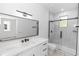 Modern bathroom featuring marble countertops, sleek black fixtures, and a glass-enclosed shower at 21 N Hampton Ave # Lot 2, Orlando, FL 32803