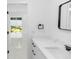 Modern bathroom featuring white marble countertops, black hardware, and sleek fixtures at 21 N Hampton Ave # Lot 2, Orlando, FL 32803