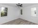 Bright, empty bedroom with wood-look floors and three windows at 21 N Hampton Ave # Lot 2, Orlando, FL 32803