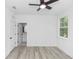 Empty bedroom featuring a ceiling fan, wood-look floors, and a bathroom entrance at 21 N Hampton Ave # Lot 2, Orlando, FL 32803