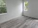 Light-filled bedroom features two windows and a neutral color scheme at 21 N Hampton Ave # Lot 2, Orlando, FL 32803