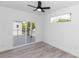 Light bedroom with a ceiling fan, light walls and sliding glass door to the outside at 21 N Hampton Ave # Lot 2, Orlando, FL 32803