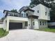 Modern two-story home with a balcony, covered parking, and manicured lawn at 21 N Hampton Ave # Lot 2, Orlando, FL 32803