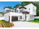 Modern two-story home with a balcony, covered parking, and fresh landscaping at 21 N Hampton Ave # Lot 2, Orlando, FL 32803