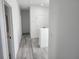 Bright hallway with wood-look flooring and modern white doors on either side at 21 N Hampton Ave # Lot 2, Orlando, FL 32803