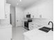 Bright kitchen featuring white cabinets, stainless steel appliances, and modern countertops at 21 N Hampton Ave # Lot 2, Orlando, FL 32803