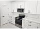 Modern kitchen features stainless steel appliances, white cabinets, and light countertops at 21 N Hampton Ave # Lot 2, Orlando, FL 32803