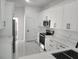 Bright kitchen featuring white cabinets, stainless steel appliances, and modern countertops at 21 N Hampton Ave # Lot 2, Orlando, FL 32803