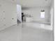 Open floor plan boasts white tile flooring, kitchen view, and ample natural light at 21 N Hampton Ave # Lot 2, Orlando, FL 32803