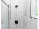 Modern shower featuring sleek black fixtures and elegant white marble-like tile at 21 N Hampton Ave # Lot 2, Orlando, FL 32803