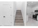 Open staircase connects to modern kitchen with stainless steel appliances and sleek white cabinets at 21 N Hampton Ave # Lot 2, Orlando, FL 32803