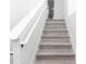 Bright stairway with light wood steps and white railing leads to upper level of home at 21 N Hampton Ave # Lot 2, Orlando, FL 32803