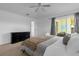 Spacious bedroom with dresser, plush bedding, and sliding door to patio at 217 Holborn Loop, Davenport, FL 33897