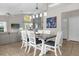 Open-concept dining area with modern lighting, vaulted ceiling, and seamless transition to the living spaces at 217 Holborn Loop, Davenport, FL 33897