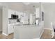 Bright kitchen with modern appliances, white cabinets, and a breakfast bar perfect for casual dining at 217 Holborn Loop, Davenport, FL 33897