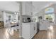 Bright kitchen features white cabinets, stainless steel appliances, and an adjacent breakfast nook with ample sunlight at 217 Holborn Loop, Davenport, FL 33897