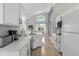Well-lit kitchen with stainless appliances, white cabinets, stone countertops, and breakfast nook is perfect for families at 217 Holborn Loop, Davenport, FL 33897
