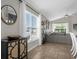 Bright living room featuring neutral decor, tile flooring, and a large window overlooking the outdoors at 217 Holborn Loop, Davenport, FL 33897