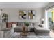 Cozy living room featuring a sectional sofa, accent pillows, and a stylish coffee table on a decorative rug at 217 Holborn Loop, Davenport, FL 33897